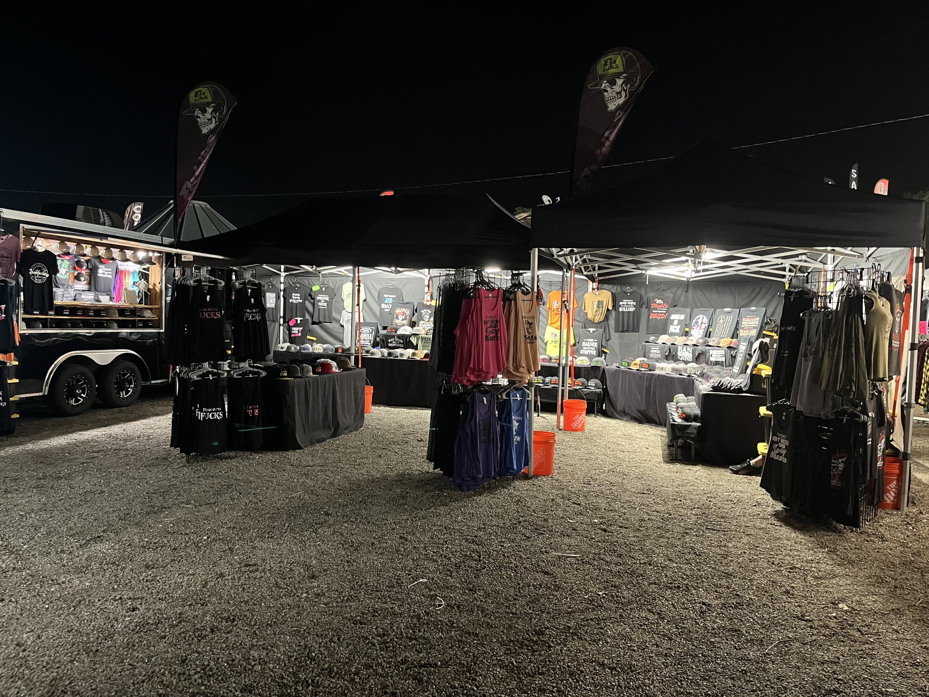 Black Label Apparel Co booth set up at a night show with merchandise on display